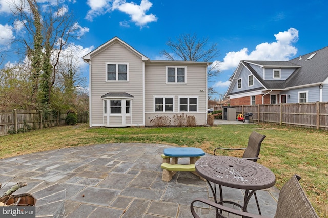 back of property featuring a patio area and a yard