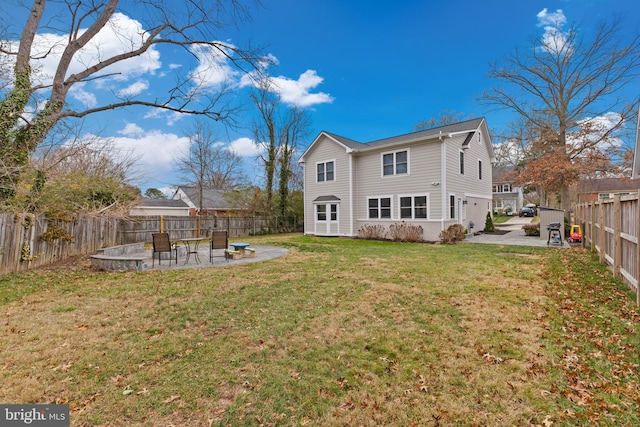 rear view of property featuring a patio and a yard