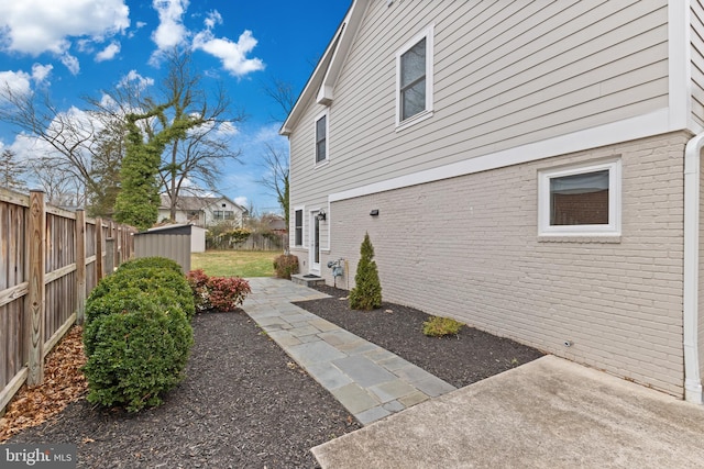 exterior space featuring a patio area and a storage unit