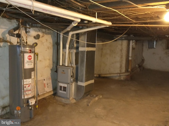 basement featuring electric panel, heating unit, and gas water heater