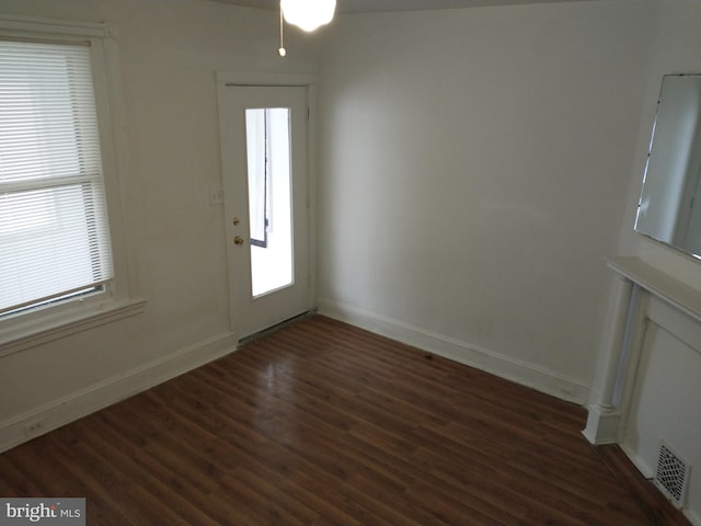 entryway with dark hardwood / wood-style flooring