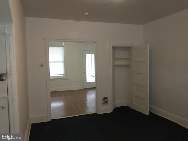 unfurnished bedroom featuring dark wood-type flooring