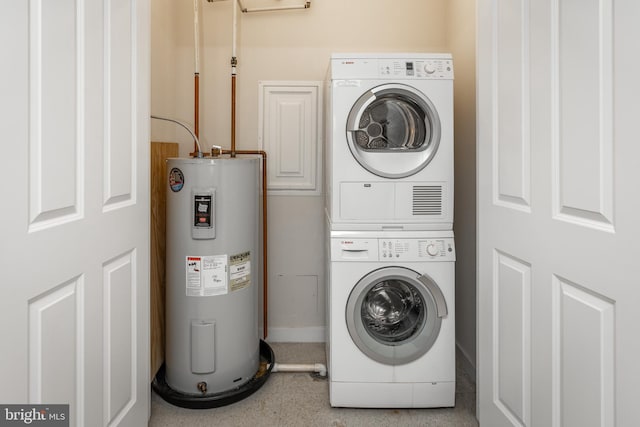 laundry room featuring cabinets, stacked washer / dryer, and water heater