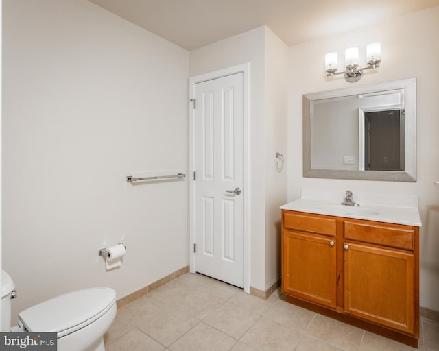 bathroom featuring tile patterned floors, vanity, and toilet