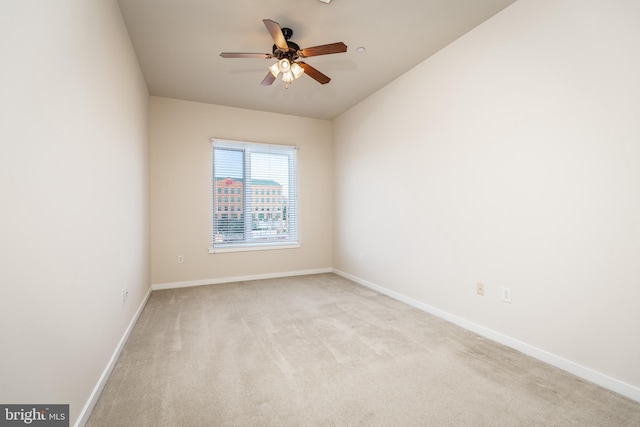 carpeted spare room featuring ceiling fan