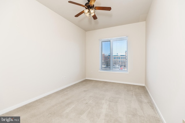 unfurnished room featuring ceiling fan and light carpet