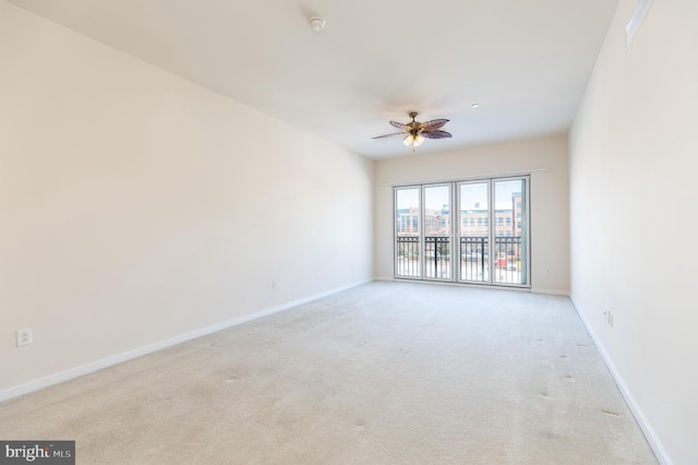 spare room with light carpet and ceiling fan