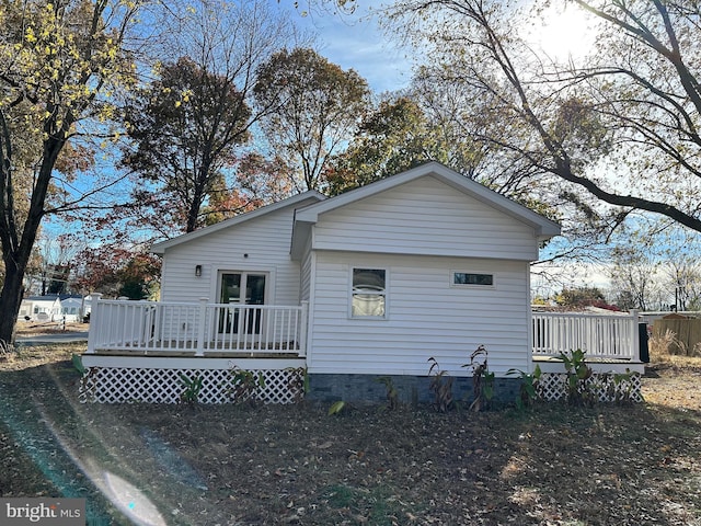 back of house featuring a deck