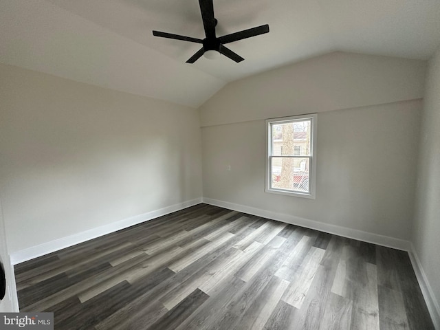 spare room featuring dark wood-type flooring, ceiling fan, and lofted ceiling