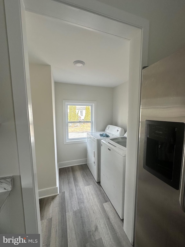 washroom featuring hardwood / wood-style floors and washer and dryer