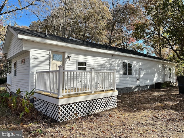 rear view of house featuring a deck