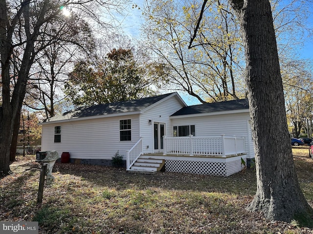 back of property with a wooden deck