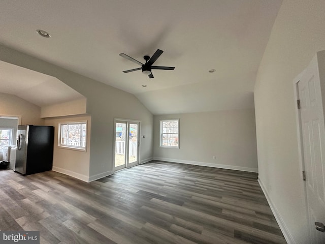 unfurnished living room with ceiling fan, lofted ceiling, and dark hardwood / wood-style flooring