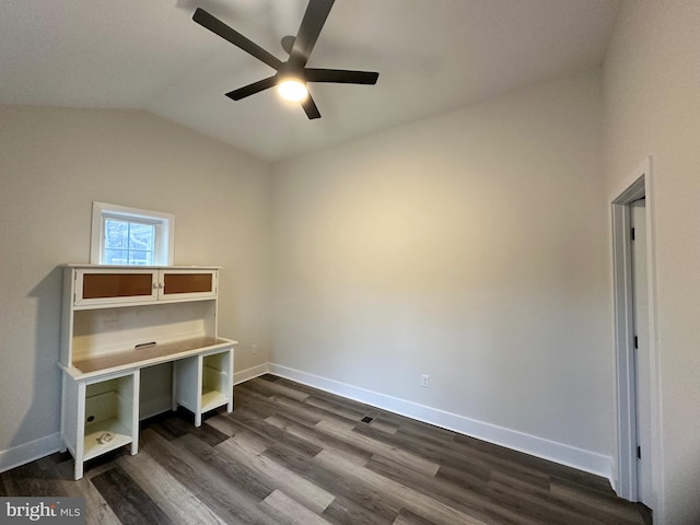 unfurnished office featuring lofted ceiling, dark wood-type flooring, and ceiling fan