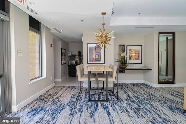 dining space featuring a notable chandelier