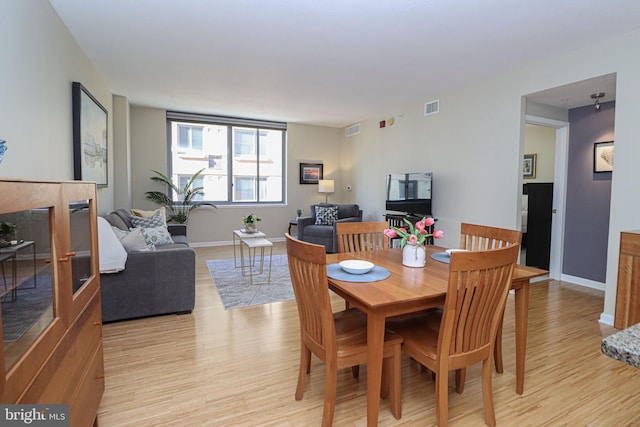 dining area with light hardwood / wood-style flooring