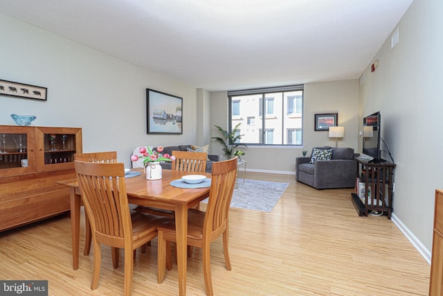 dining space with light wood-type flooring