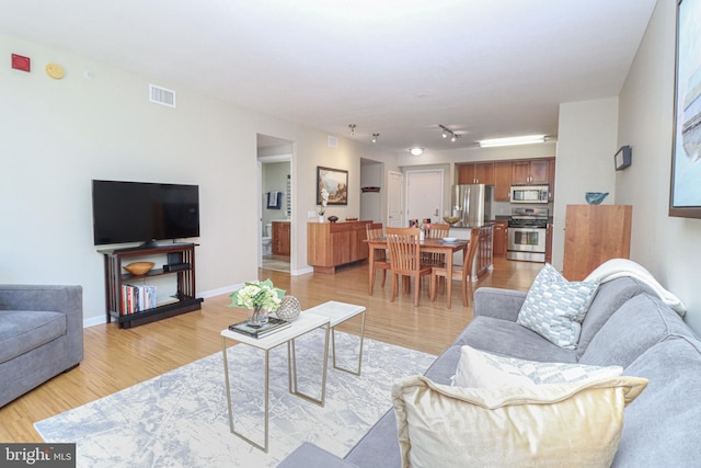 living room with light hardwood / wood-style floors