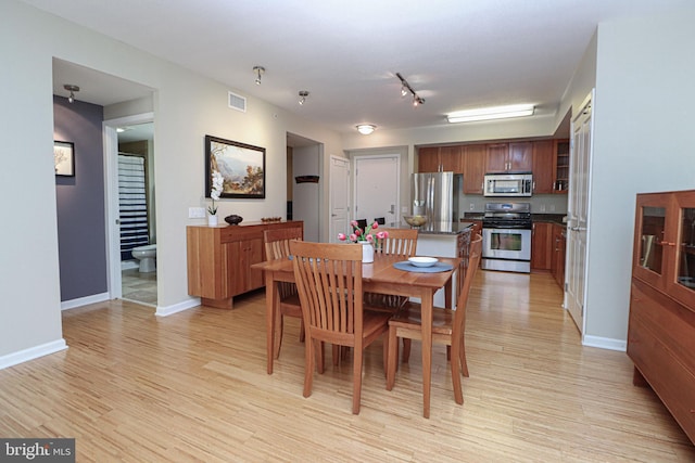 dining area with light hardwood / wood-style floors