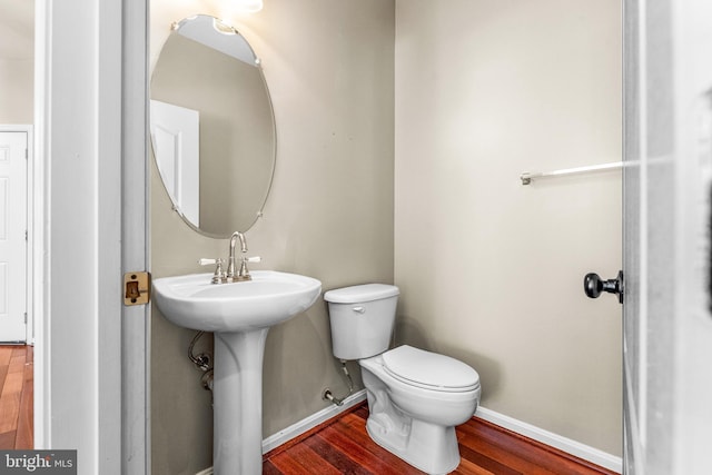 bathroom featuring hardwood / wood-style floors and toilet