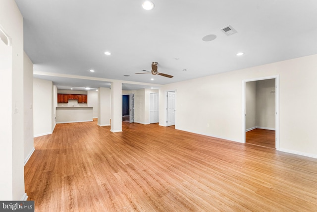 unfurnished living room with ceiling fan and light hardwood / wood-style flooring