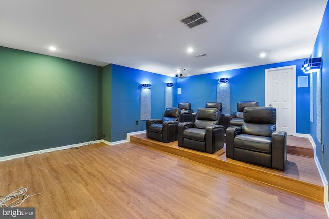 home theater room with wood-type flooring