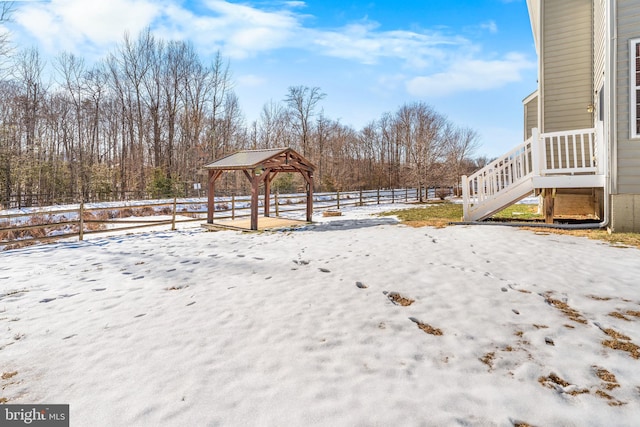 snowy yard featuring a gazebo