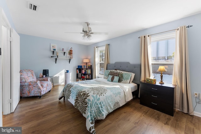 bedroom with ceiling fan and dark hardwood / wood-style floors