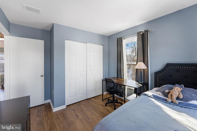 bedroom with a closet and dark wood-type flooring