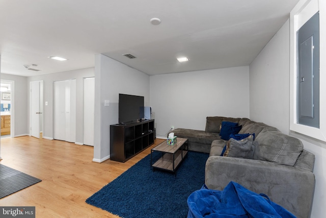 living room featuring electric panel and hardwood / wood-style flooring