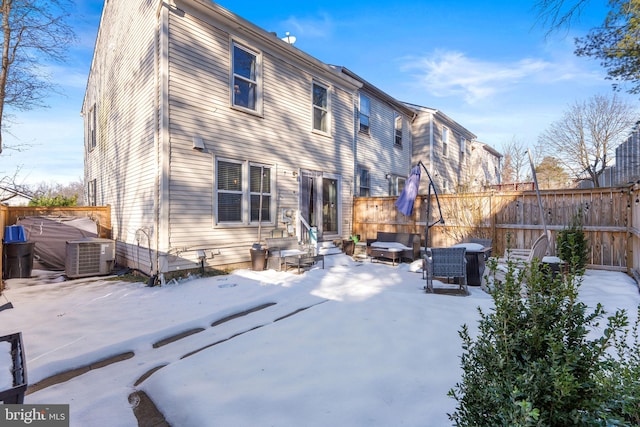 snow covered property with cooling unit