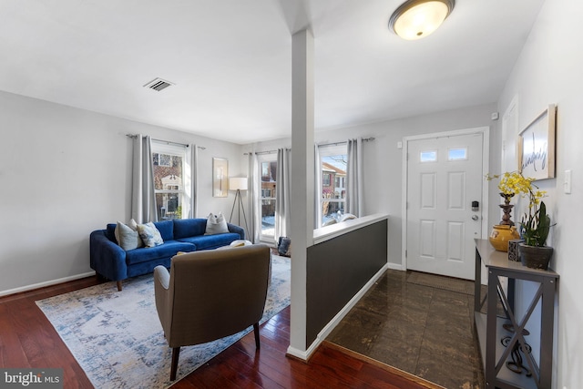 entrance foyer featuring a healthy amount of sunlight and dark hardwood / wood-style floors