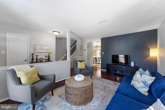 living room with a chandelier and hardwood / wood-style flooring