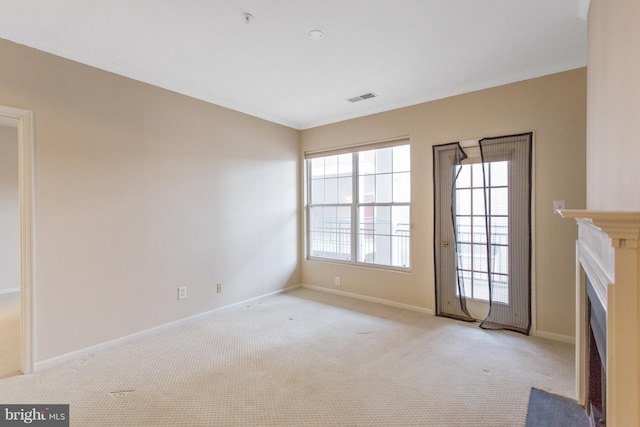 unfurnished living room with light carpet and crown molding