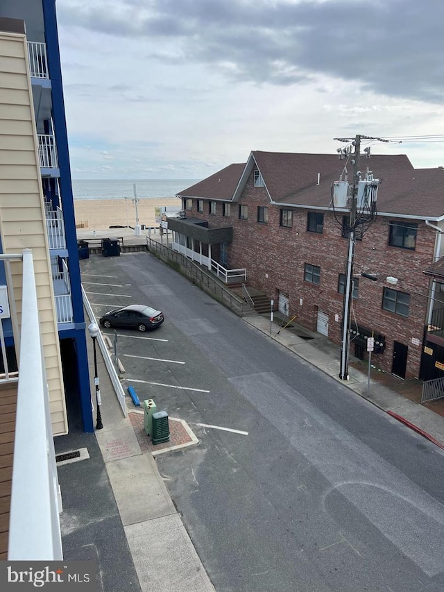 view of vehicle parking with a water view