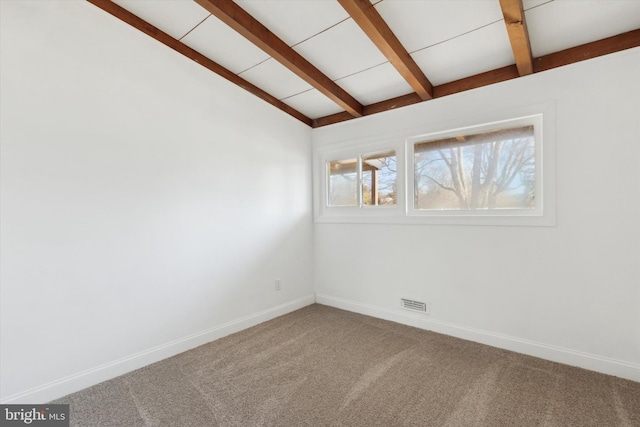 unfurnished room with vaulted ceiling with beams and carpet floors