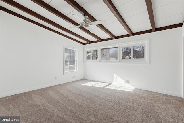 spare room with ceiling fan, carpet, and vaulted ceiling with beams