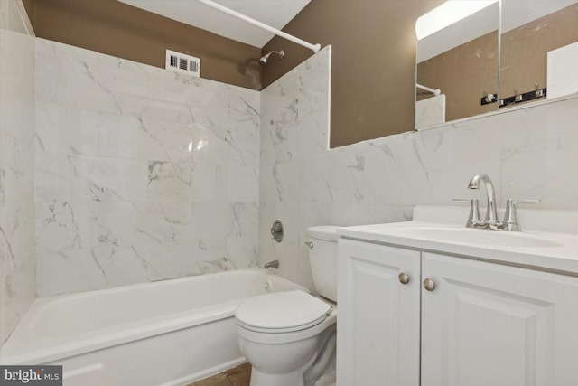 full bathroom with toilet, tile walls, backsplash, tiled shower / bath combo, and vanity