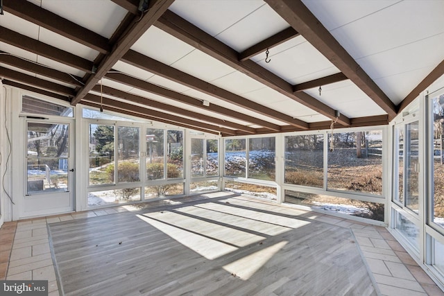 unfurnished sunroom with lofted ceiling with beams