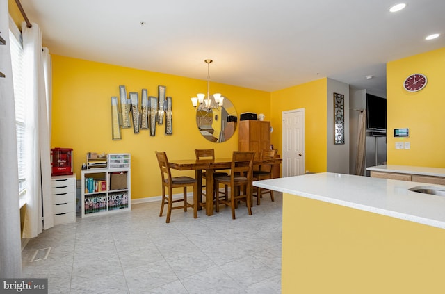 dining area with an inviting chandelier