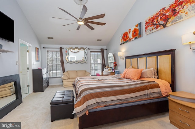 bedroom featuring ceiling fan, high vaulted ceiling, and light carpet