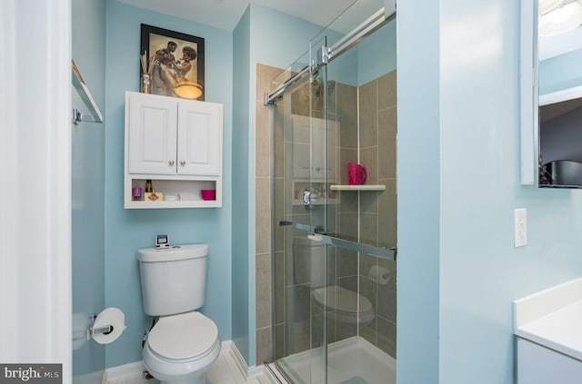 bathroom with a shower with shower door and toilet