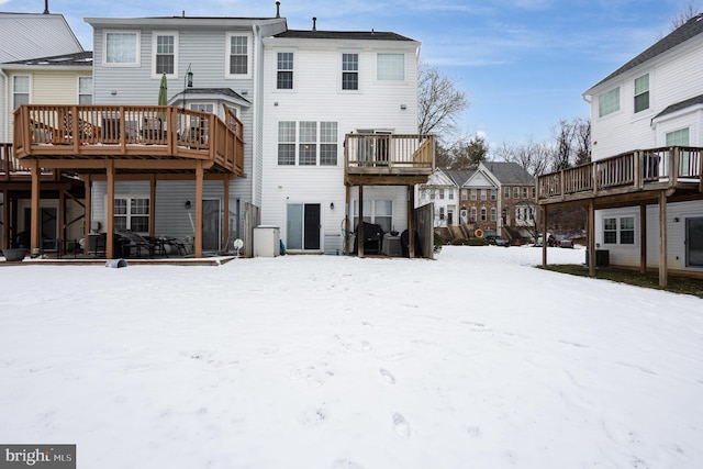 snow covered property featuring a deck