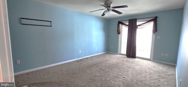 empty room featuring ceiling fan and carpet