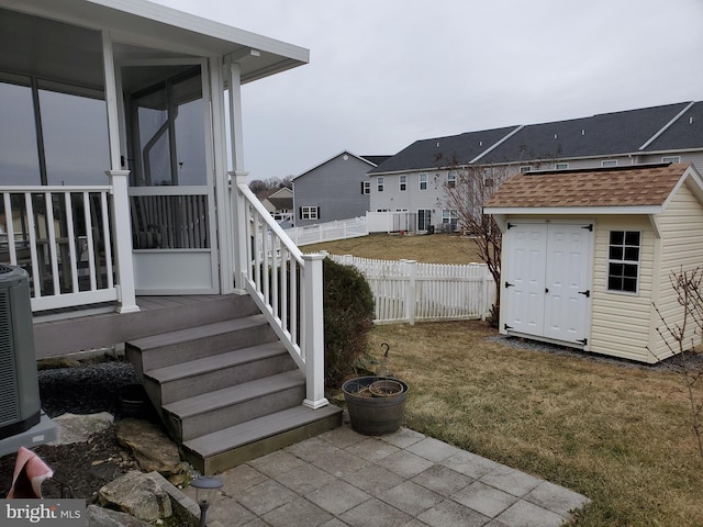 view of yard with cooling unit and a storage unit