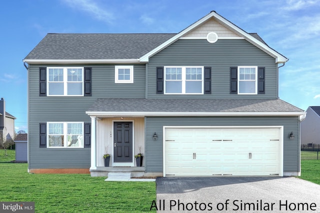 view of front property with a garage and a front lawn