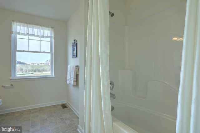 bathroom with shower / bath combination with curtain