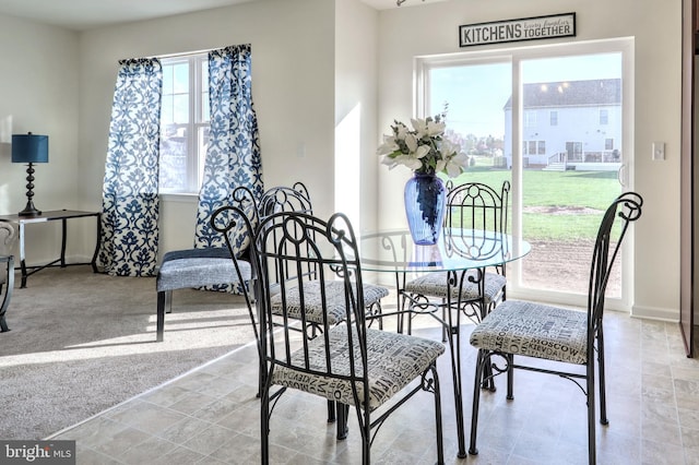 dining space with light colored carpet