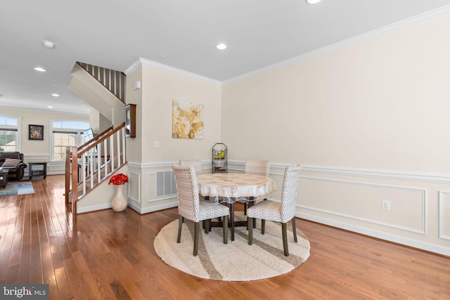 dining area featuring crown molding and hardwood / wood-style floors