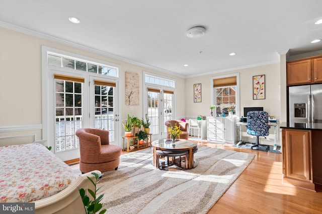 living room with light hardwood / wood-style flooring, crown molding, and french doors